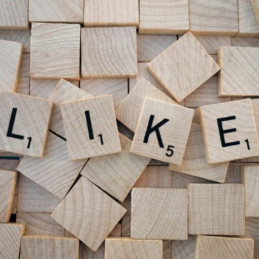 like printed on brown wooden scrabble